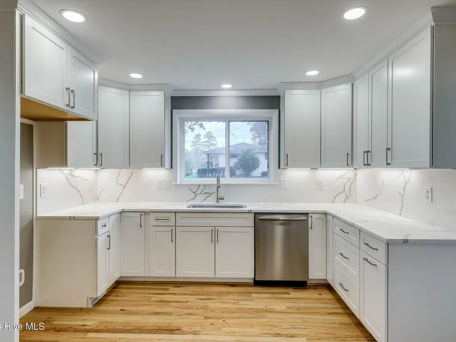 Kitchen sink wall with quartz counters and stainless dishwasher at 1135 Crestview Avenue