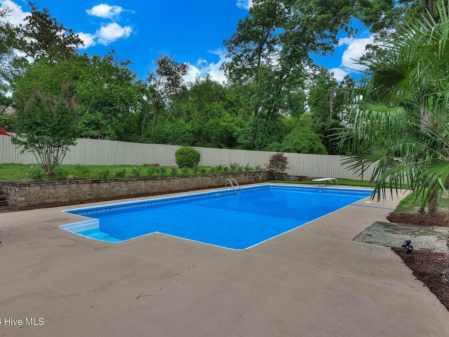Wide view of the restored private pool and deck at 1135 Crestview Avenue