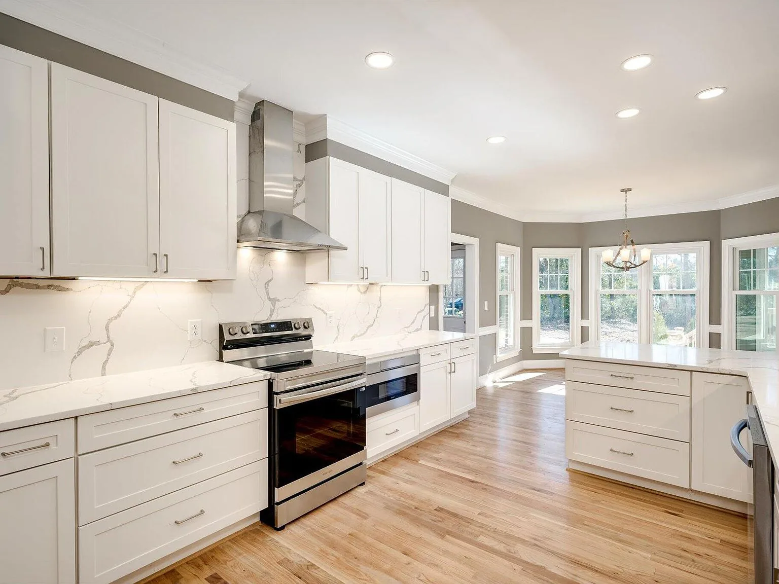 Kitchen with stainless range, marble backsplash and stone counters at 2 Shadowmoor Court