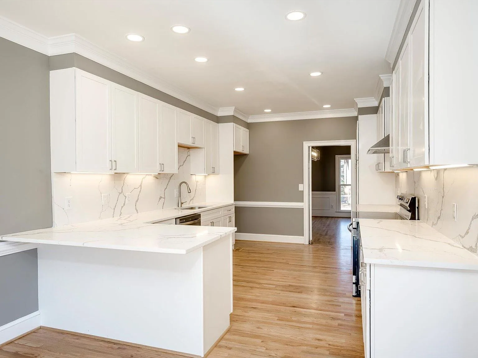 Kitchen island and breakfast nook opening to the main living area at 2 Shadowmoor Court