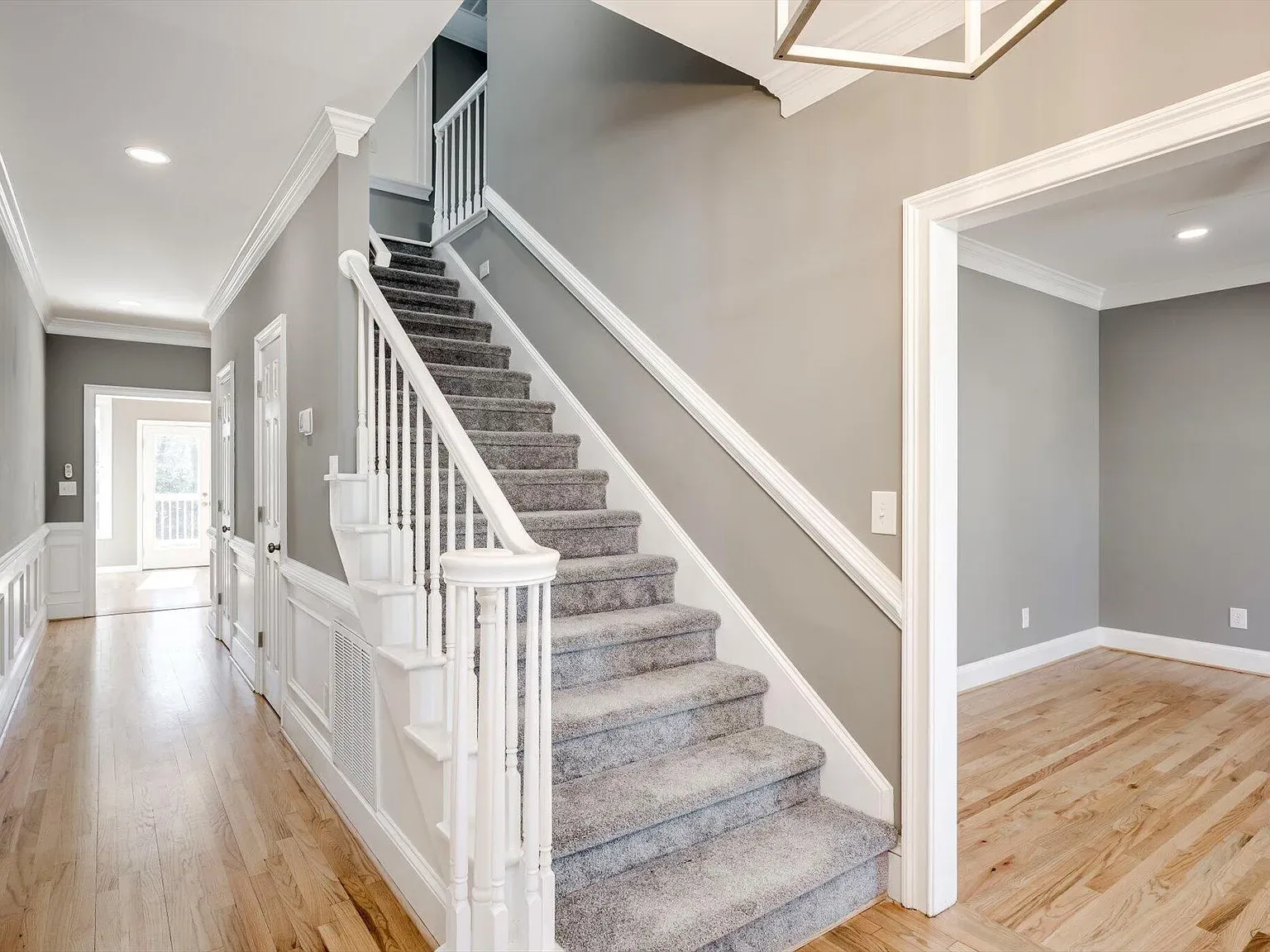 Refinished staircase and entry hall at 2 Shadowmoor Court