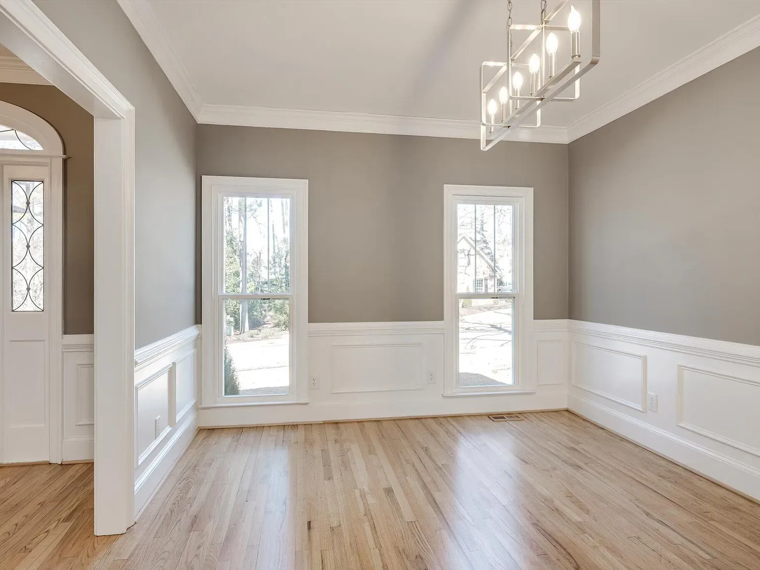 Sunroom with wraparound windows overlooking the rear deck at 2 Shadowmoor Court
