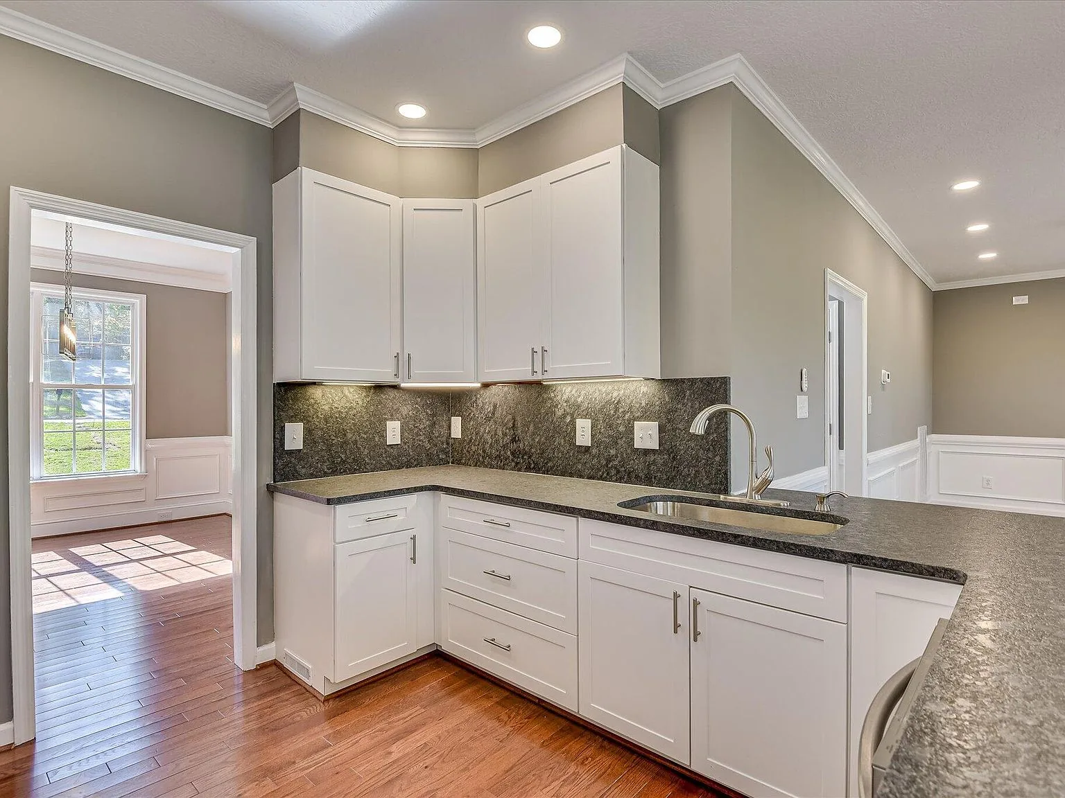 Second view of the renovated kitchen with granite peninsula at 2008 Rivershyre Drive
