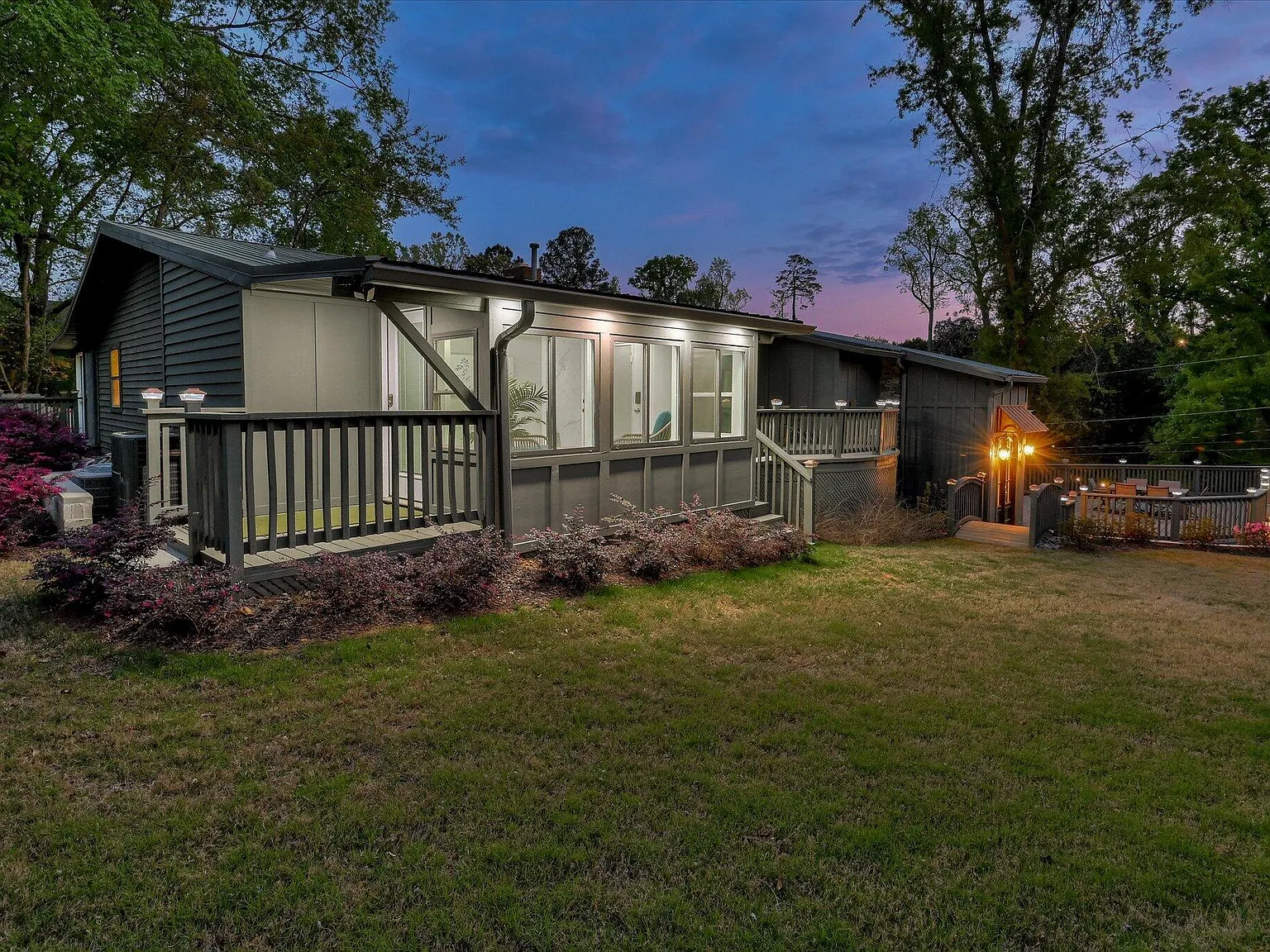 Rear elevation and standing-seam metal roof at 2417 Wilkshire Drive at dusk