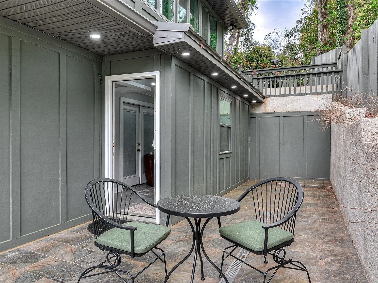 Covered patio with bistro seating at 2417 Wilkshire Drive