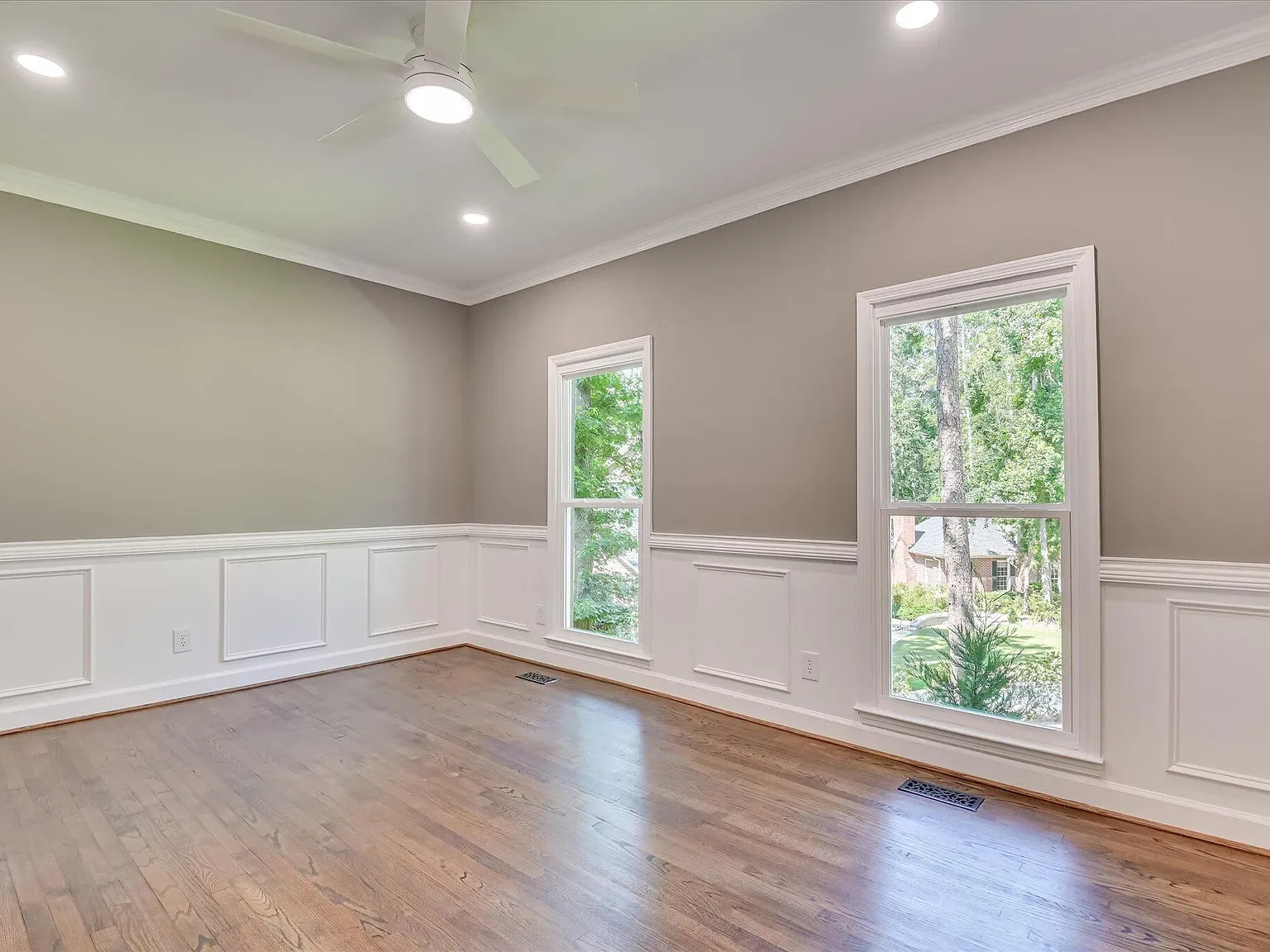 Dining room with wainscoting and refinished hardwood at 4 Shadowmoor Court