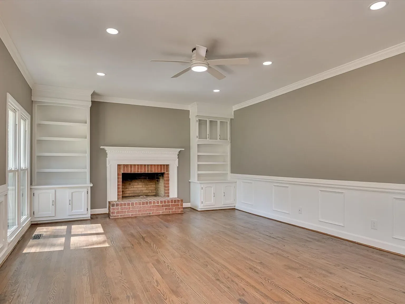 Living room fireplace flanked by custom built-ins at 4 Shadowmoor Court