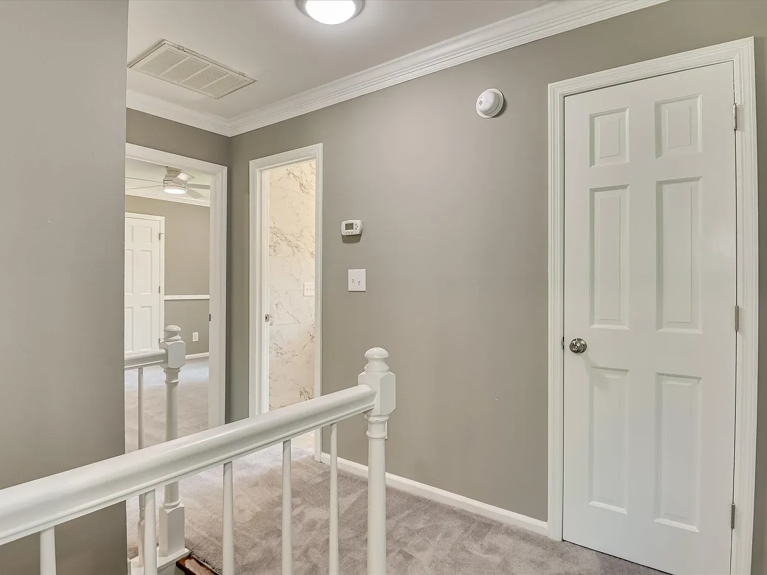 Upstairs landing and hallway with new doors and trim at 4 Shadowmoor Court