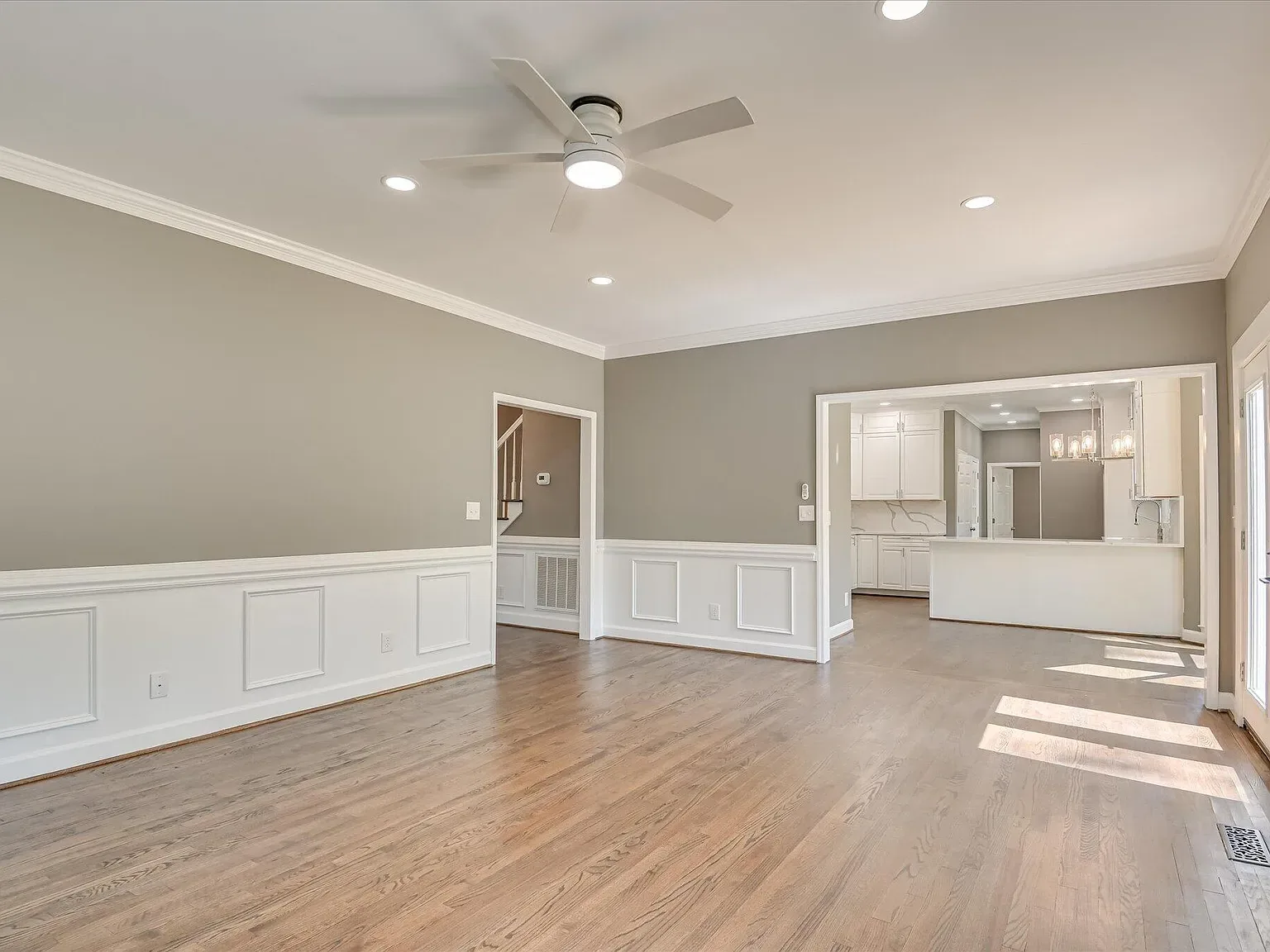 Main living area opening to the renovated kitchen at 4 Shadowmoor Court