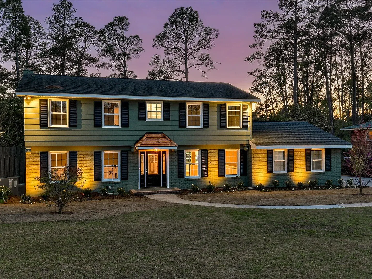 814 Dunbarton Drive lit at dusk after exterior renovation