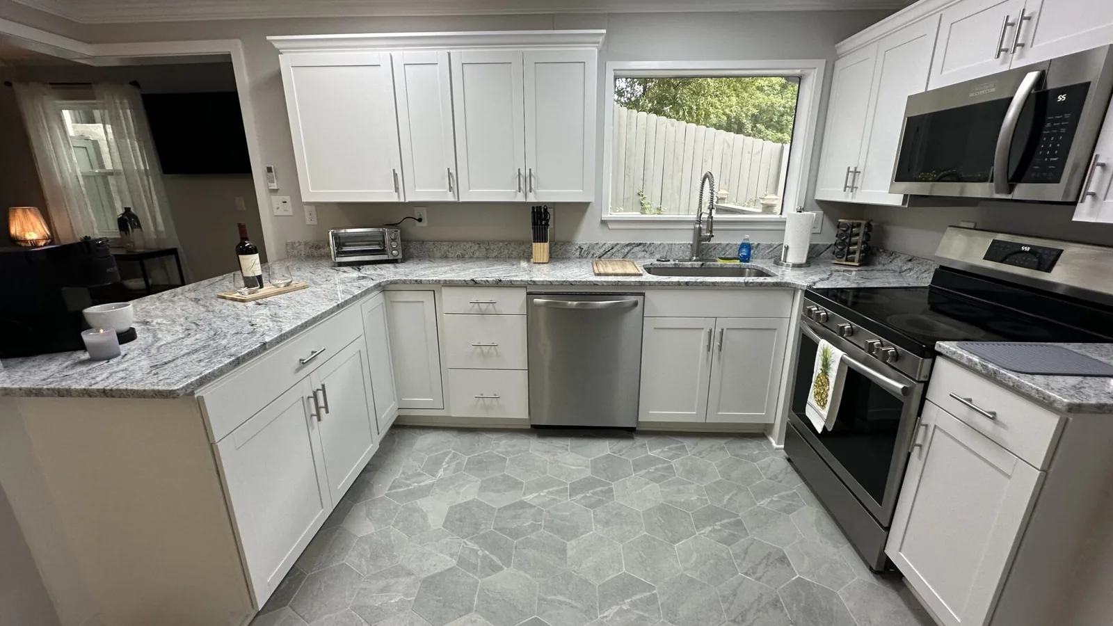Renovated kitchen at 2417 Wilkshire Drive with a large island, stone counters and full-height cabinetry