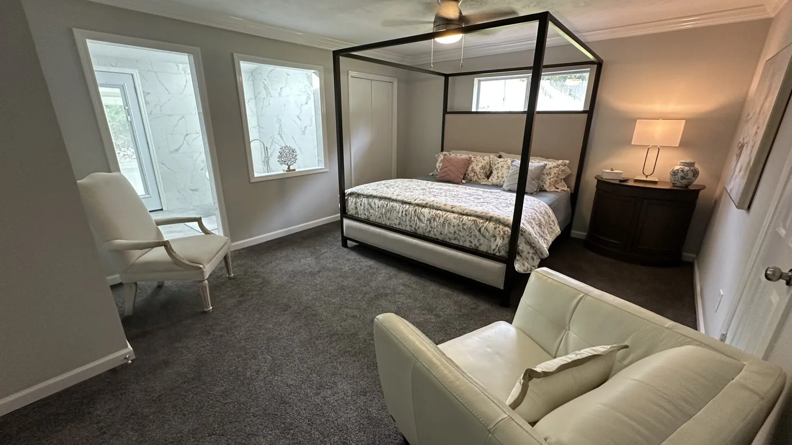 Guest bedroom with a four-poster bed and sitting chair at 2417 Wilkshire Drive