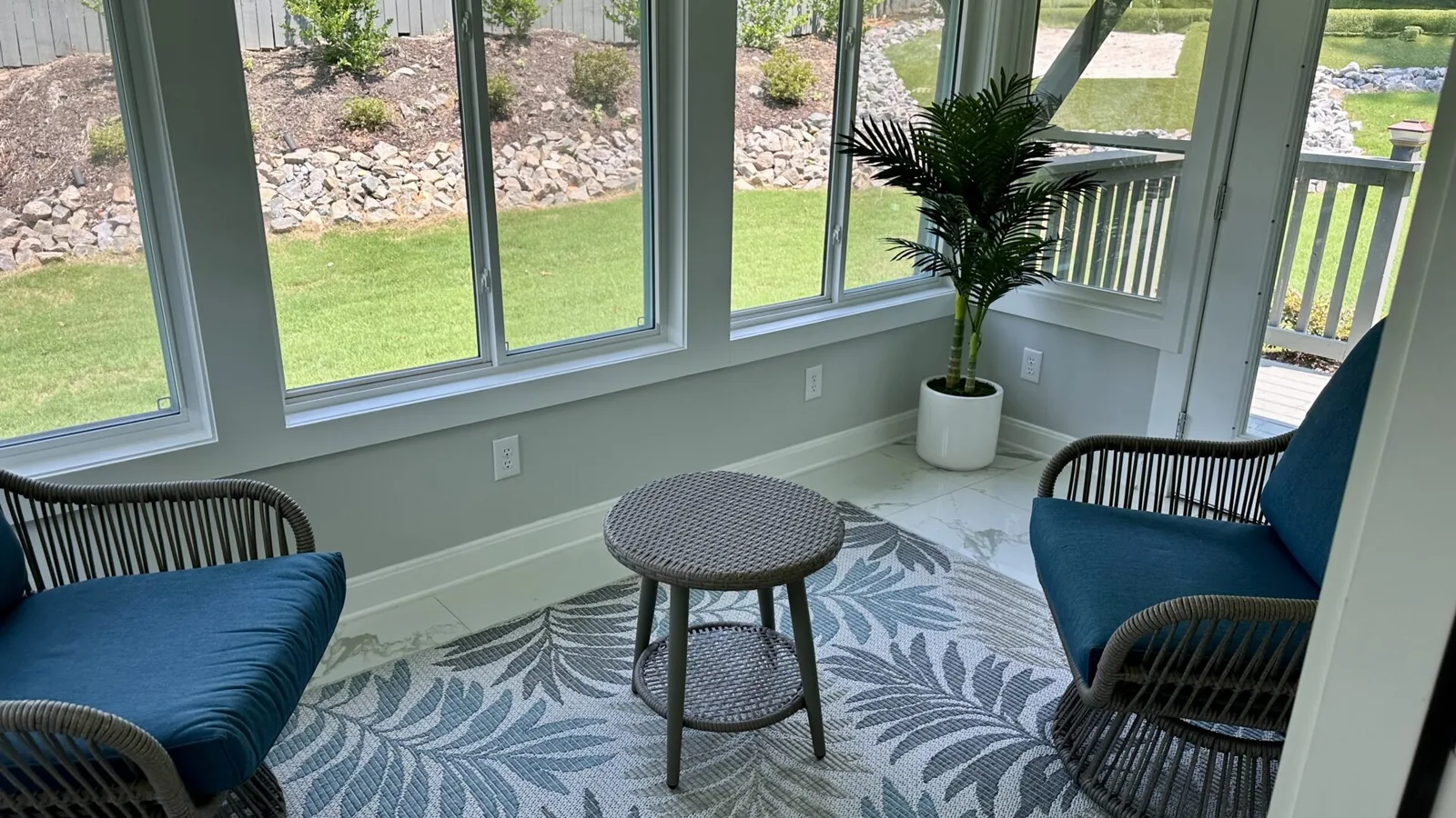 Sunroom seating area with windows onto the rear yard at 2417 Wilkshire Drive