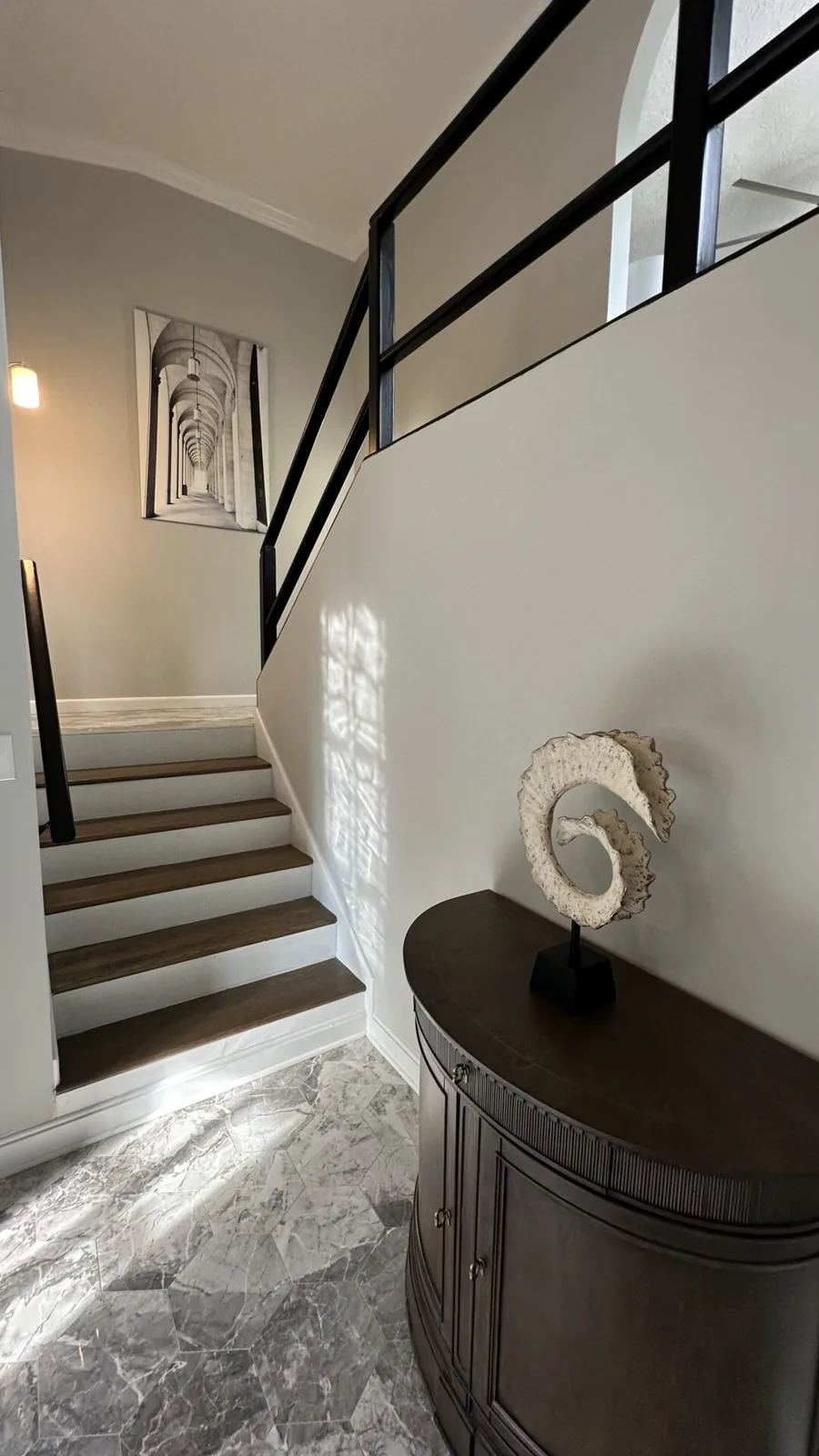 Rebuilt staircase with refinished treads and new railing at 2417 Wilkshire Drive