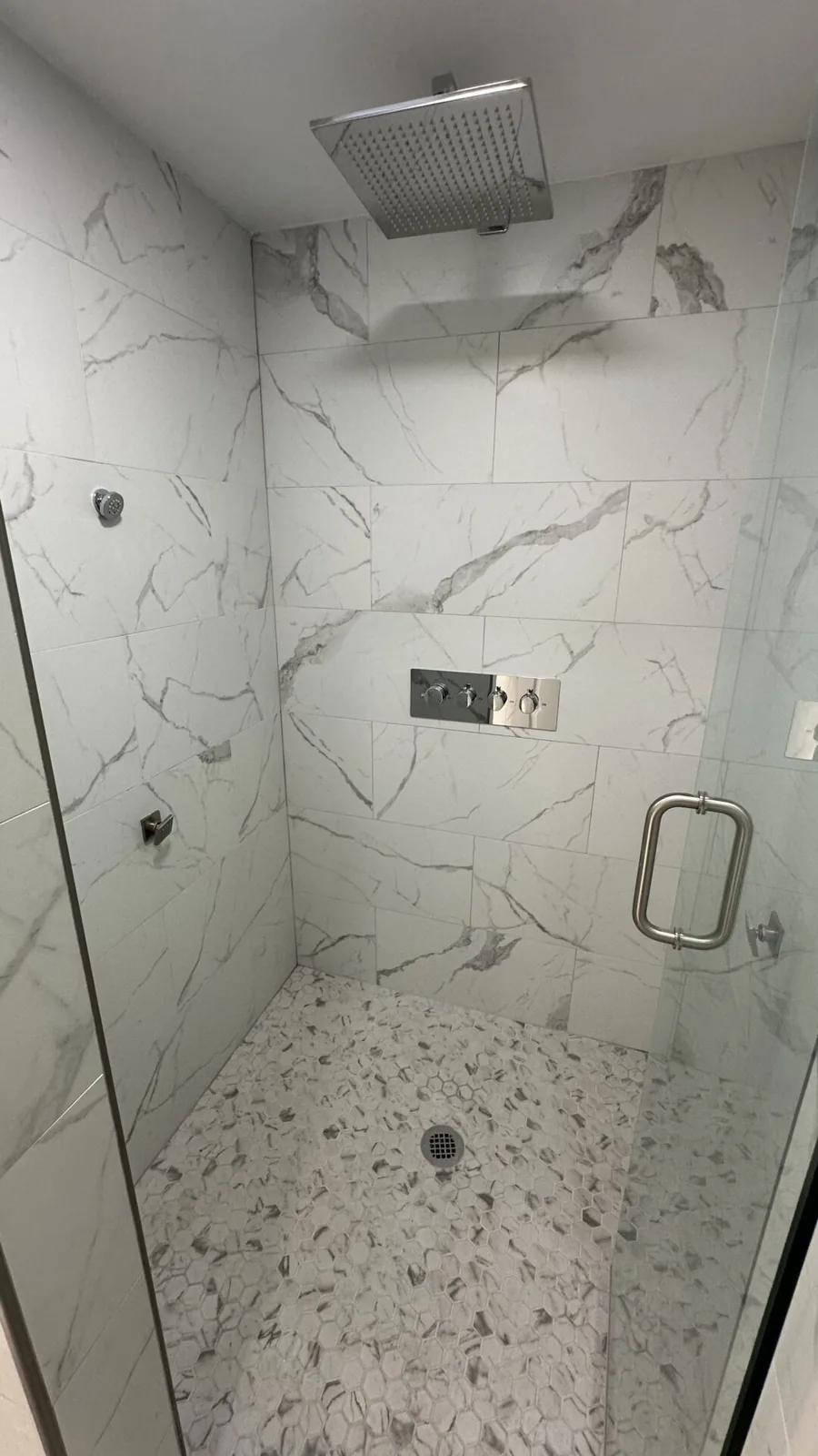 Tiled walk-in shower with glass enclosure at 2417 Wilkshire Drive